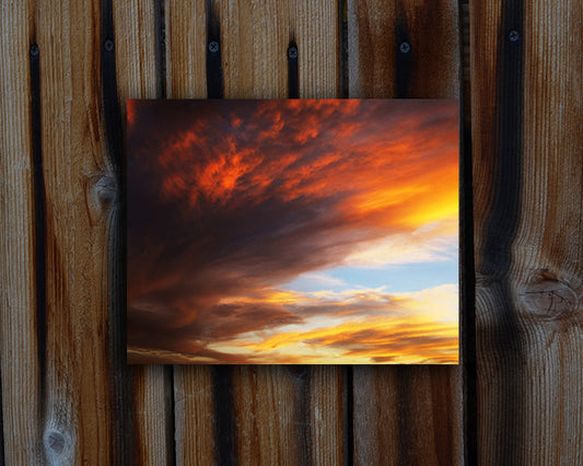 Photographic print of a dramatic glowing red, yellow and blue sunset called Blissful by Loud Hue