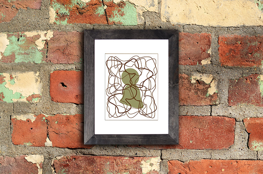 Art print of olive green human silhouette with overlapping brown lines called Human mounted with black frame by loud Hue