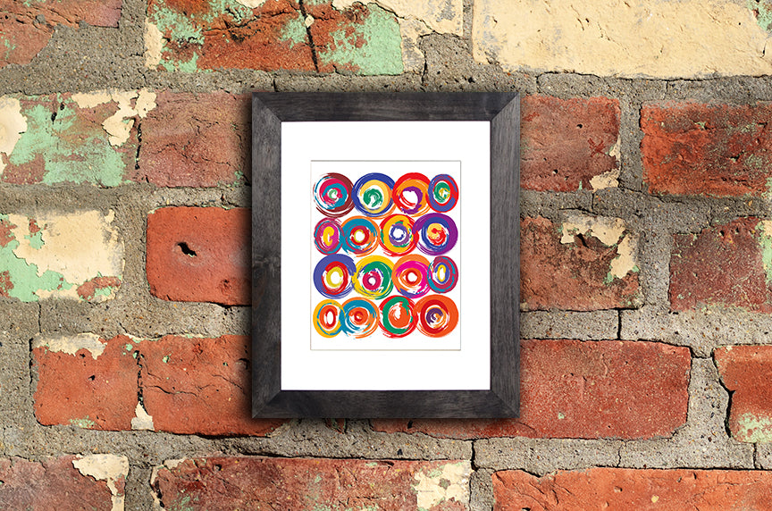 Art Print of energetic and colorful circles with a brushstroke effect shown mounted with a black frame called Jolt by Loud Hue