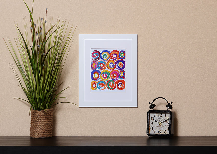 Art Print of energetic and colorful circles with a brushstroke effect shown with a white frame called Jolt by Loud Hue
