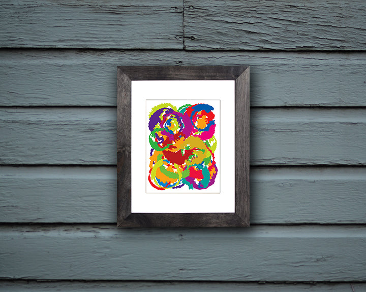 Abstract Art Print resembling the moon in vibrant colors shown mounted in black frame called Luna by Loud Hue