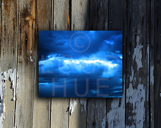 Dramatic photographic print of a turbulent blue sky shown mounted without a frame called Ocean by Loud Hue
