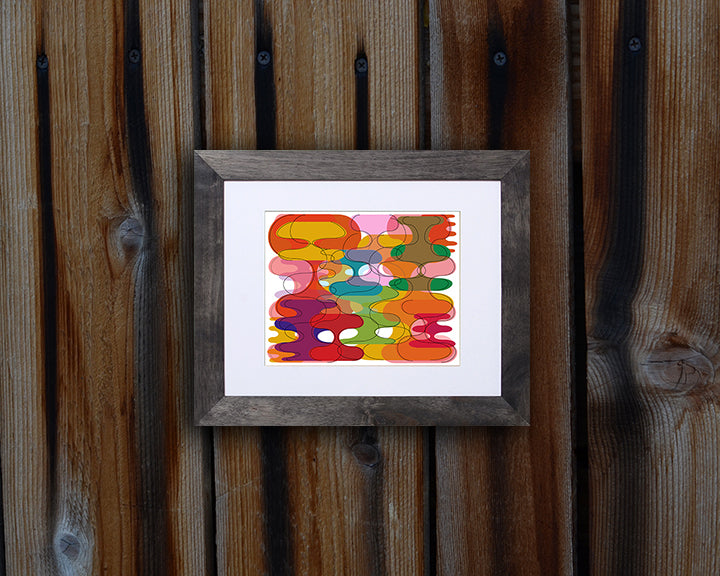 Retro style Art Print of vibrant geometric shapes shown mounted with a black frame called Reflect by Loud Hue