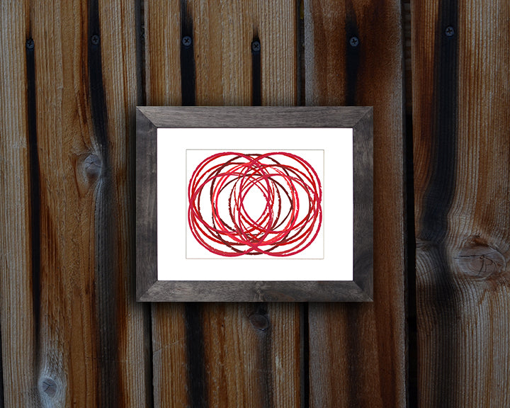 Modern Art Print of overlapping circles in hues of red shown mounted with a black frame called Soul by Loud Hue