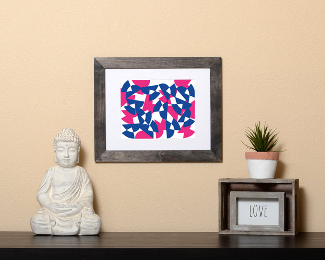 Pop art style Art Print in pink and blue overlapping shapes shown with a black frame called Bound by Loud Hue