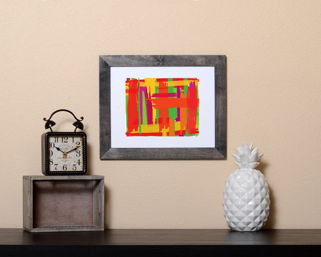 Art Print of an abstract design in vivid colors with a paint brush effect shown with a black frame called Prismatic by Loud Hue