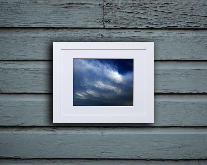 Nature photography print of glorious blue and white clouds shown mounted with a white frame called Blue by Loud Hue