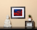 Nature photography print of a glowing red sunset with a black frame called Cotton Candy by Loud Hue