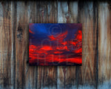 Nature photography print of a glowing red sunset shown mounted without a frame called Cotton Candy by Loud Hue