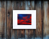 Nature photography print of a glowing red sunset shown mounted with a white frame called Cotton Candy by Loud Hue