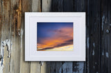 Photographic print of a celestial sunset with blue and yellow tones called Heavenly Glow by Loud Hue