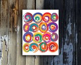 Art Print of energetic and colorful circles with a brushstroke effect shown mounted without a frame called Jolt by Loud Hue