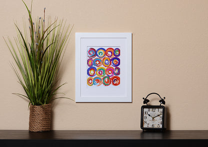Art Print of energetic and colorful circles with a brushstroke effect shown with a white frame called Jolt by Loud Hue