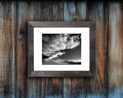 Black and White photographic print of a dramatic sky with black frame called Luminous by Loud Hue