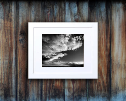 Black and White photographic print of a dramatic sky with white frame called Luminous by Loud Hue