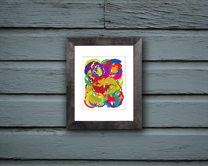 Abstract Art Print resembling the moon in vibrant colors shown mounted in black frame called Luna by Loud Hue