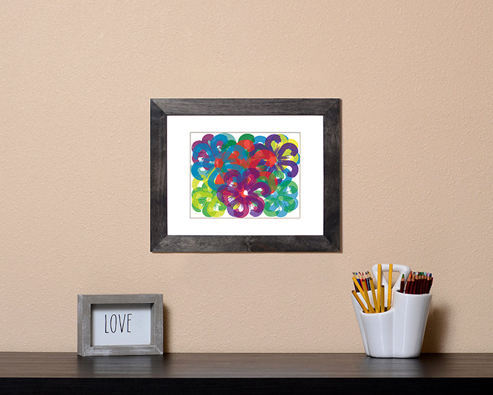 Art Print of overlapping flowers in cheerful bright colors shown in a black frame called Spring by Loud Hue