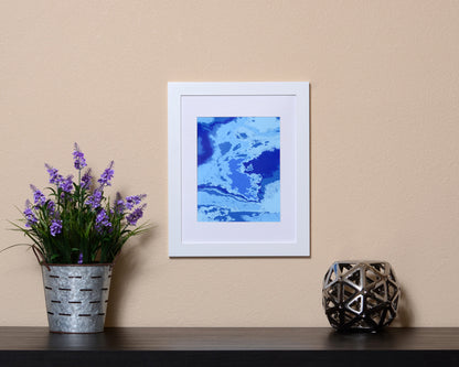 Vibrant Abstract Art Print in the form of waves with hues of blues shown with a white frame called Boundless by Loud Hue