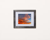 Beautiful nature print of a glowing sunset illuminating the sky with black frame called Glow by Loud Hue