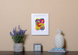 Abstract Art Print resembling the moon in vibrant colors in white frame called Luna by Loud Hue