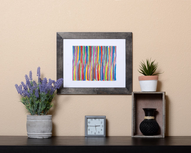 Abstract Art Print in multicolor lines with paint brush effect shown with a black frame called Fused by Loud Hue